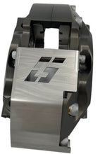 Load image into Gallery viewer, A brake caliper with a stainless steel guard mounted to it on a white background