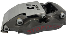 Load image into Gallery viewer, A brake caliper with a stainless steel guard mounted to it on a white background