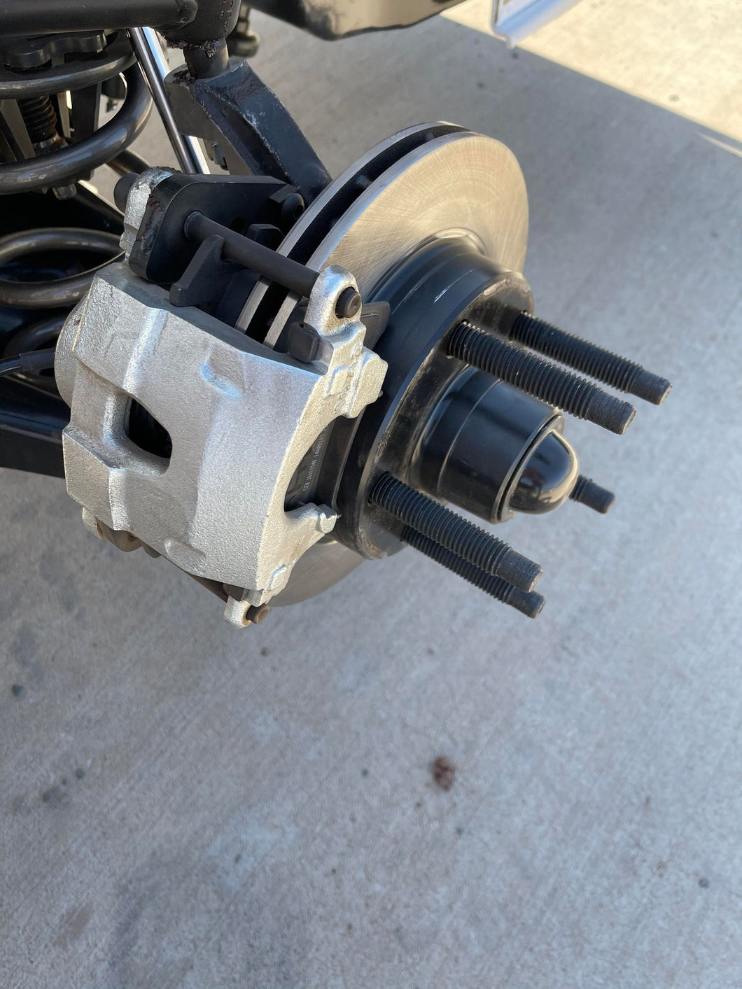 A hub rotor installed on a dirt modified showing the brake caliper