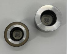 Load image into Gallery viewer, Top-down picture of two brake caliper pistons showing a two digit number embossed in the base of the pistons.