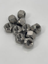 Load image into Gallery viewer, Titanium lug nuts, approximately 10, in a pile on a white background
