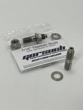 Load image into Gallery viewer, Two titanium studs, nuts, and washers on a white background with packaging in the background
