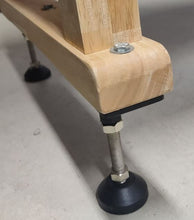 Load image into Gallery viewer, Picture of the adjustable foot pad installed as a leg for a workbench or table