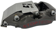 Load image into Gallery viewer, A brake caliper with a stainless steel guard mounted to it on a white background
