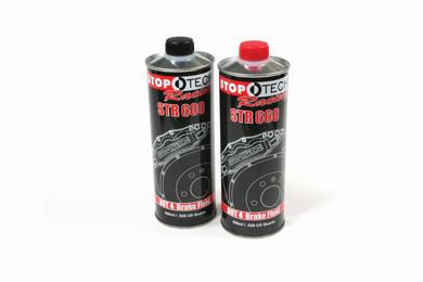 Two cans of brake fluid on a white background