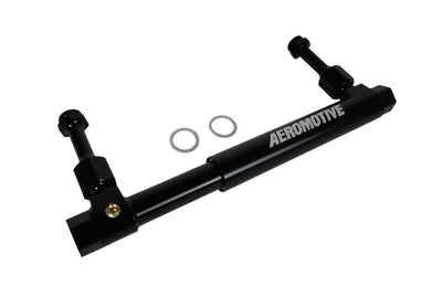A black Aeromotive brand adjustable fuel log on a white background
